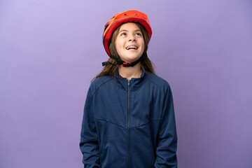 Little caucasian girl isolated on purple background laughing