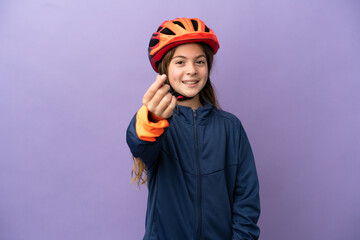 Little caucasian girl isolated on purple background making money gesture