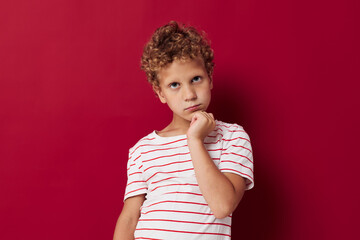 photo of a boy with curly hair in casual clothes emotions
