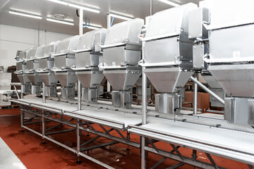 Meat processing plant. Production line of meat.Line for the production of meat with packaging and cutting . Industrial equipment at a meat factory