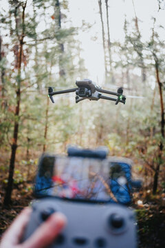 Flying drone in countryside in forest