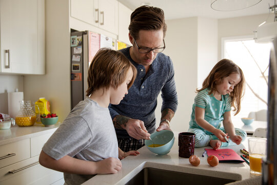 Father and children in morning kitchen