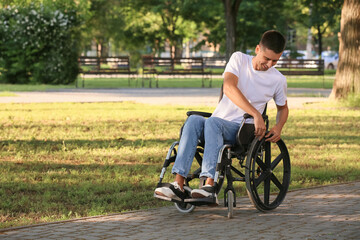 Young man with physical disability in park