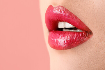 Beautiful young woman with pink lips on color background, closeup