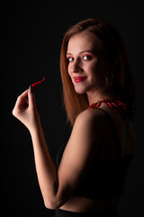Obraz premium Beautiful Young Smiling Woman Holding Red Hot Chili Pepper.