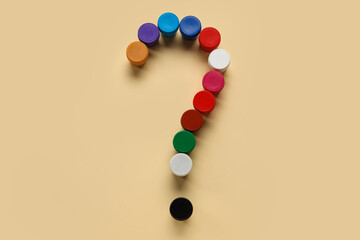 Question mark made of gouache paints on beige background