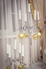 silver chandelier with candles decorated for Christmas