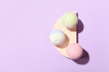Bath bombs on lilac background
