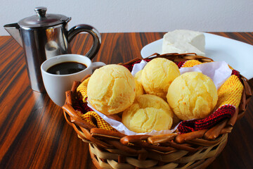 Closeup of basket of cheese bread. Traditional afternoon coffee consumed in Brazil. Seletive focus.