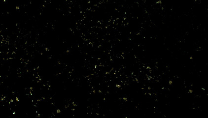 Gold sparkled carnival confetti on black background