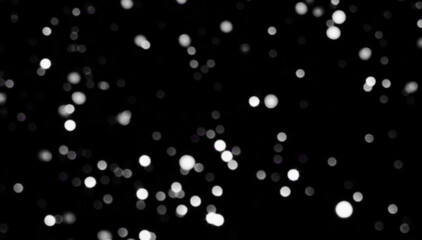 White grey bokeh on the black background