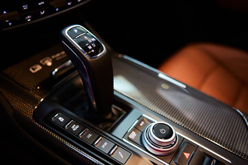 Automatic gear stick of a modern car, multimedia and navigation control buttons. Car interior...