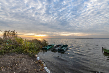 Colorful sunrise on the shores of Lake Nero. Autumn landscape with a lake in the early morning. A...