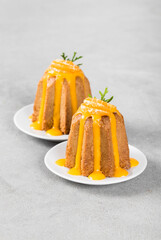 Italian cake, citrus Pandora with icing sugar on a plate on a light gray background