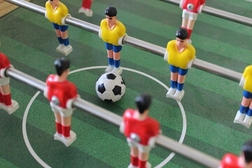 Close up of some players and soccer ball on a foosball table