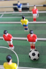 Close up of some players and a soccer ball from a table foosball game