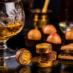 glass of cognac and  chocolate pralines 