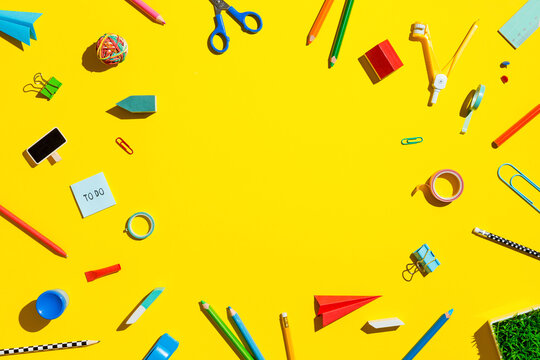 School supplies on yellow background. Back to school. Top view.