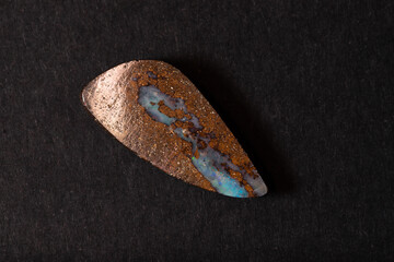 Colorful boulder opal gem from Winton Australia on black background