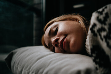 woman sleeping on sofa in winter morning