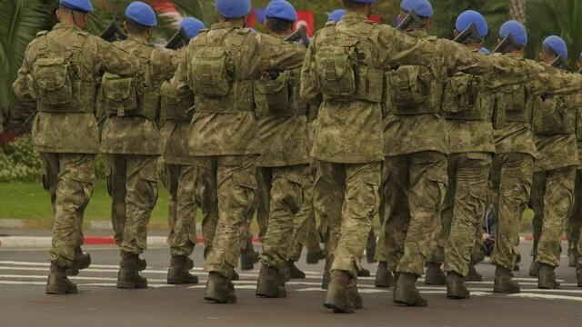Back view of the Turkish commando soldiers with blue beret walking on lockstep at the republic day of Turkey 29 October 2021