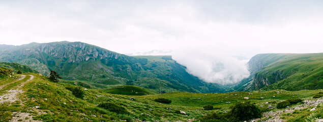 Panorama of mountains and valleys in dense fog in Durmitor National Park