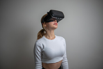 woman in white shirt wearing vr glasses, studio photo on white background