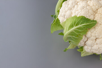 Cauliflower isolated on gray background. Copy space. Cooking recepies. White and green. Vegetarian. Organic. Top right corner.
