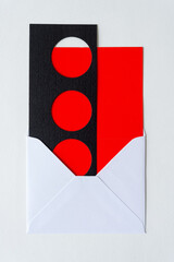 envelope with red card and paper element with circles
