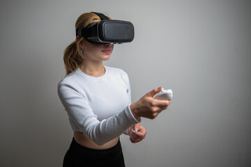 Woman wearing VR glasses and spending time controlling with joystick