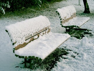 Tokyo,Japan - January 6, 2022: Snow-covered bench at TsurumakiNishi Park in Tokyo, Japan

