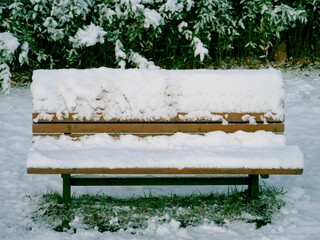 Tokyo,Japan - January 6, 2022: Snow-covered bench at TsurumakiNishi Park in Tokyo, Japan
