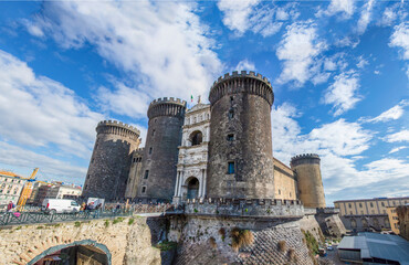 Wide view of the New Castle (Castel Nuovo) in Naples, Italy, in the sunny winter day, with white...