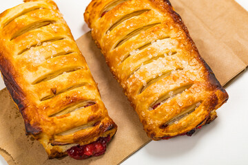 Puff Pastry Fruit Berry Strudel on White Wooden Background. Selective focus.