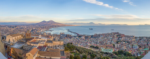 Fototapeta premium Wide angle view of City of Naples, mount Vesuvius and Gulf of Naples from the top of San Elmo Castle in the evening