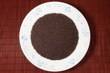 brown mustard seeds spice or rai in plate top view - obrazy, fototapety, plakaty