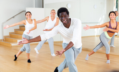 Group of multinational activity people practicing dance techniques