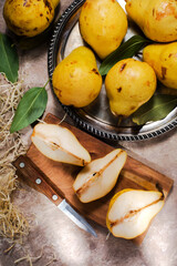 Naklejka na ściany i meble ripe yellow pears on a silver platter and a knife.