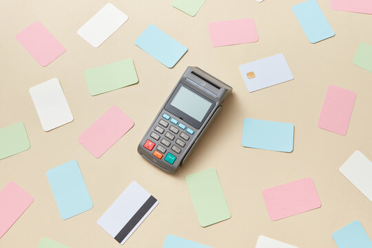 Colorful credit cards around payment terminal