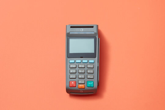 POS terminal on orange background