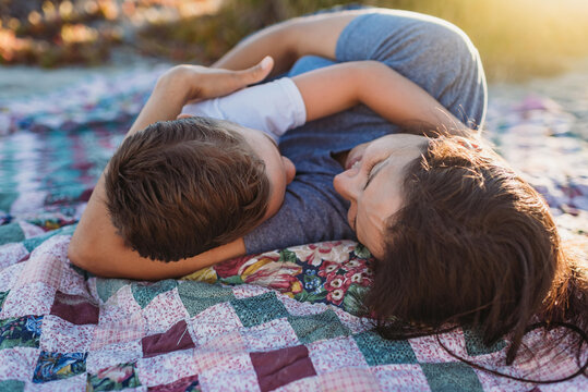 Loving mother with son on outdoor blanket