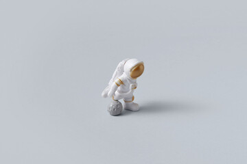 Astronaut playing soccer with moon ball