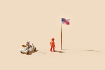 Astronauts placing flag and riding space rover