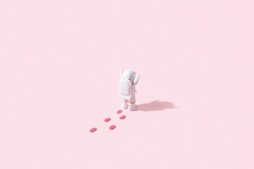 Astronaut with footprints on pink background