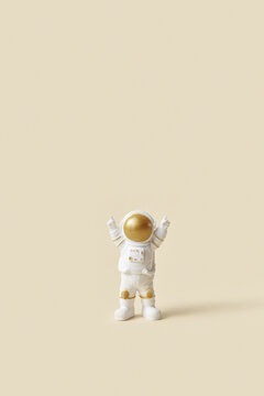 Toy Astronaut Raising Hands Up