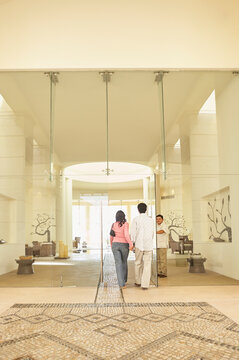 Couple arriving at luxury hotel reception lobby