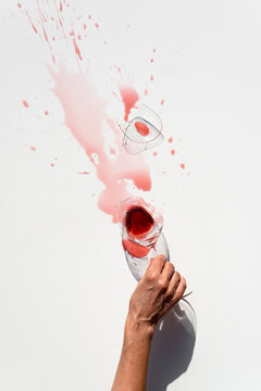 Lady holding glass with spilled wine
