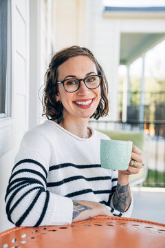 Portrait of smiling woman holding cup of coffee