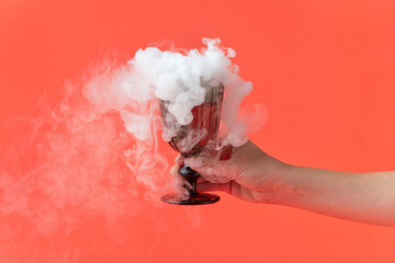 Woman holding glass with smoke