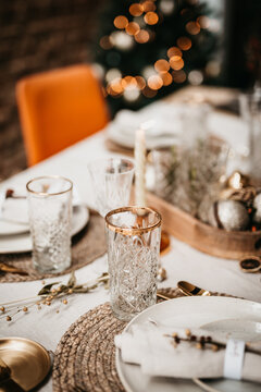 Close up of a Christmas table set with warm theme